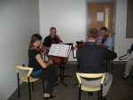 A string quartet entertains
us while we eat and chat
